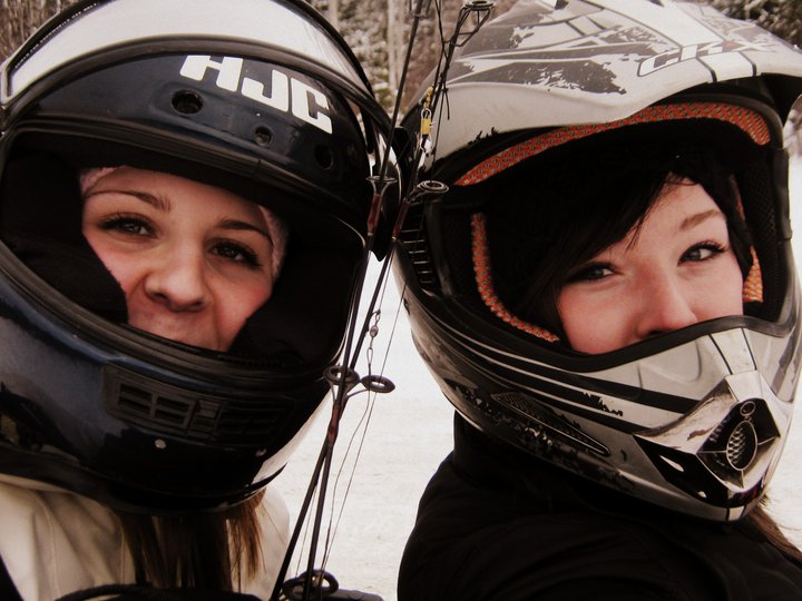 two snowmobile riders